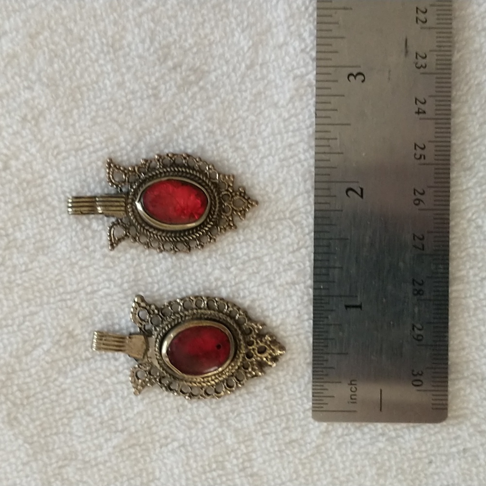 Pair of Middle Eastern brass tone pendants with red glass stone